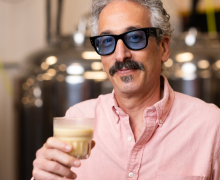 Dr. Brett Taubman holds a glass of Rootsii.